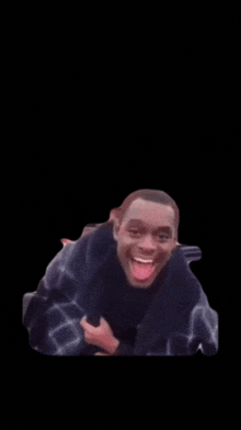 a man is laying down with his tongue hanging out and smiling