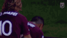 a group of soccer players wearing purple jerseys with the word mapei on them