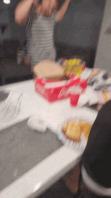 a box of coca cola sits on a table surrounded by food