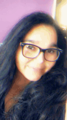 a girl wearing glasses and a fur coat looks at the camera
