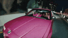 a pink car is driving down a highway with the dor brothers written on the side