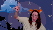 a woman wearing glasses and a headband with ears points up