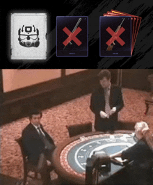 a man in a suit sits at a table with a stack of cards and a box with a x on it