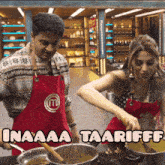 a man and a woman wearing red aprons with the letter m on it