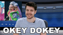 a man is sitting in front of a screen that says okey dokey