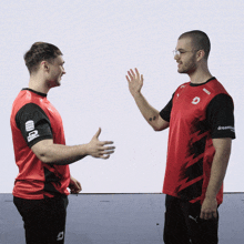 two men are shaking hands and one has a shirt that says dreamhub