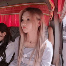 a girl with long blonde hair is wearing a shirt that says ' gh ' on the front
