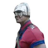 a man wearing a red shirt and a silver helmet looks at the camera