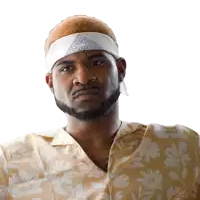 a man wearing a bandana and a shirt with flowers on it