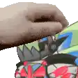 a person 's hand is touching a cartoon character 's head .