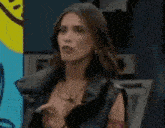 a woman is standing in front of a yellow smiley face .