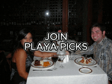 a man and woman sit at a table with a sign that says join playa picks above them