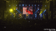 a crowd watching a concert with a gifrun.com watermark