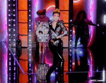 a woman in a sequined jacket is dancing on a stage with a caption that says tayce tumblr