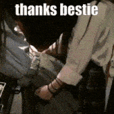 a person is holding a piece of paper with the words `` thanks bestie '' on it .