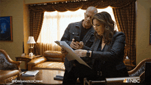 Taking A Quick Photo Of The Document Detective Elliot Stabler GIF - Taking A Quick Photo Of The Document Detective Elliot Stabler Cassandra Webb GIFs