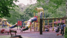 a blurred image of a playground with the word bull on the bottom left