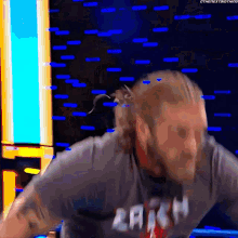 a man with a beard is wearing a shirt that says ' reign ' on it