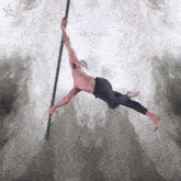 a man without a shirt is hanging from a pole with a star in the background