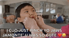 a woman is putting her hand on a young boy 's face and making a funny face .