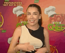 a woman is making a funny face in front of a chef hat .