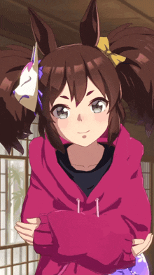 a girl with pigtails and a mask on her head is wearing a pink hoodie