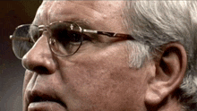 a close up of a man wearing glasses with a nike logo