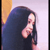 a close up of a woman 's face with black hair