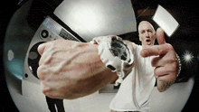 a man wearing a white watch is giving a thumbs up sign