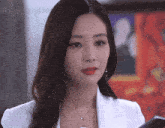 a woman in a white jacket is holding a cellphone