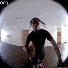 a ring camera shows a man in a black shirt standing in a hallway