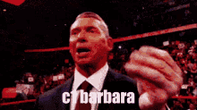 a man in a suit and tie is giving a speech in front of a crowd and says barbara