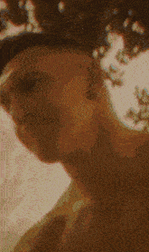 a close up of a person 's face with a blurred background