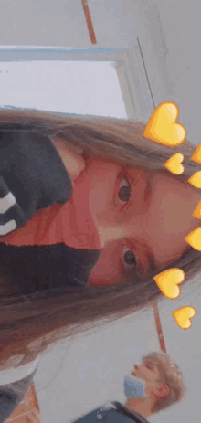 a girl wearing a mask with yellow hearts on it