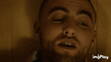 a close up of a man 's face with the words imgplay visible