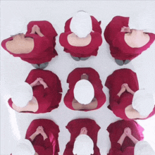 a group of women wearing red dresses and white hats are sitting in a circle