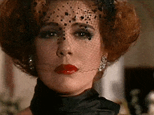 a close up of a woman wearing a veil and red lips