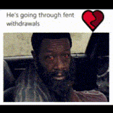 a man with a beard is sitting in a car with blood coming out of his eyes
