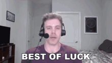 a man wearing headphones and a microphone says best of luck