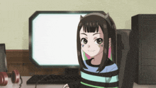 a girl with horns on her head sitting in front of a computer