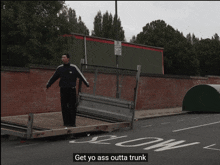 a man is standing next to a trailer that says slow on it