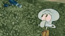 squidward from spongebob squarepants is covering his nose with his hand while standing in the grass .