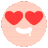 a smiley face with red hearts in its eyes and a white smile .