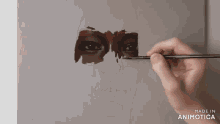a painting of a woman 's face is being painted with the words made in animotica below it