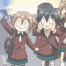 a group of anime girls are standing next to each other holding hands and waving .