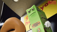 a box of crispy cinnamon logs stands next to a donut