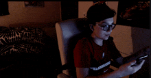 a young man wearing glasses and a red shirt that says supreme