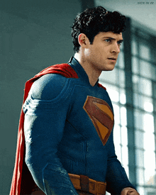 a man in a superman costume is standing in front of a window with the caption men in 4k