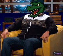 a man is sitting in a chair with a crocodile mask on his head