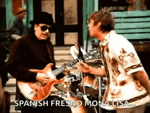 a man playing a guitar next to a man playing drums with the words " spanish fresno mona lisa " on the bottom